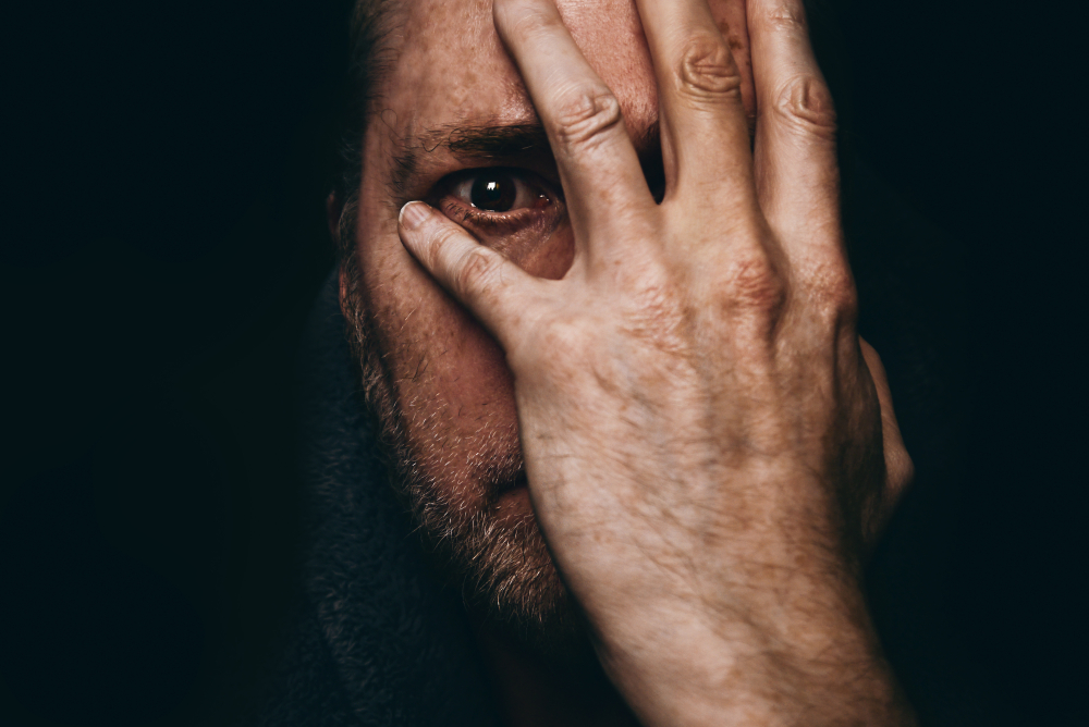 Grieving,Man,After,Receiving,Shocking,Or,Bad,News,,With,Hand