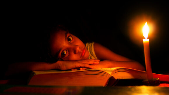 An,Indian,Girl,Trying,To,Study,In,Candle,Light,,Electricity,