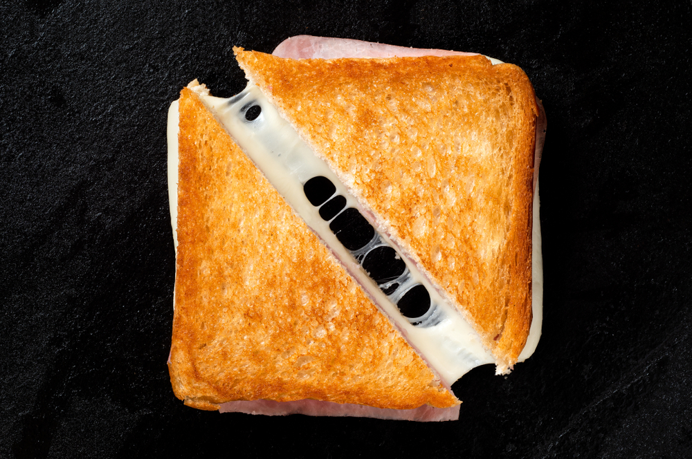 Classic,Cheese,And,Ham,Toasted,Sandwich,Cut,In,Half,Isolated