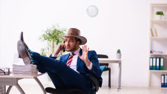 Young,Businessman,Cowboy,Working,In,The,Office