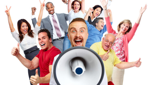 Young,Man,Talking,In,Loud hailer,And,Group,Of,Happy,People.
